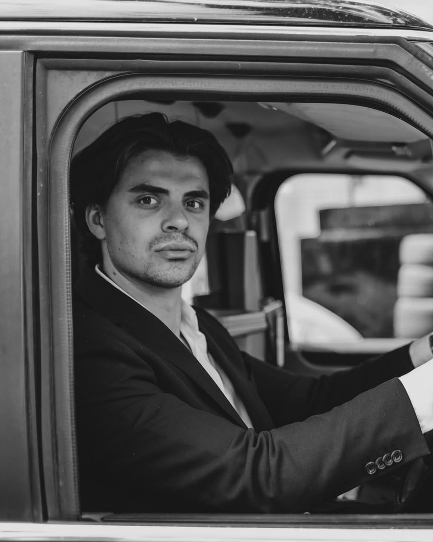 Jack Barwick at the wheel of a black cab.