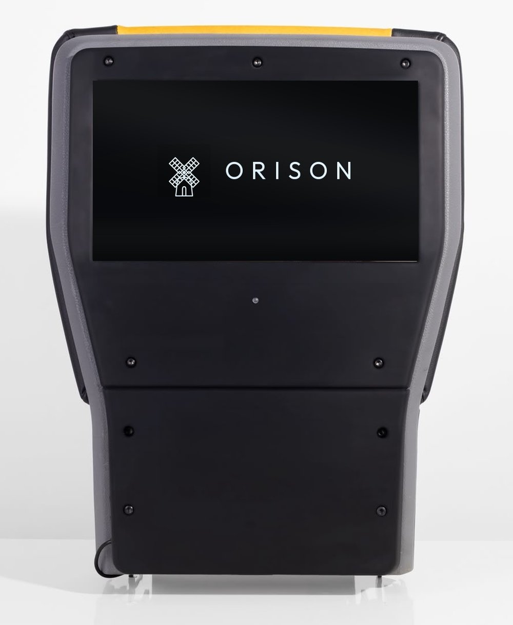 The Orison unit photographed against a white background, the display set into the back of a black cab tip-up seat.